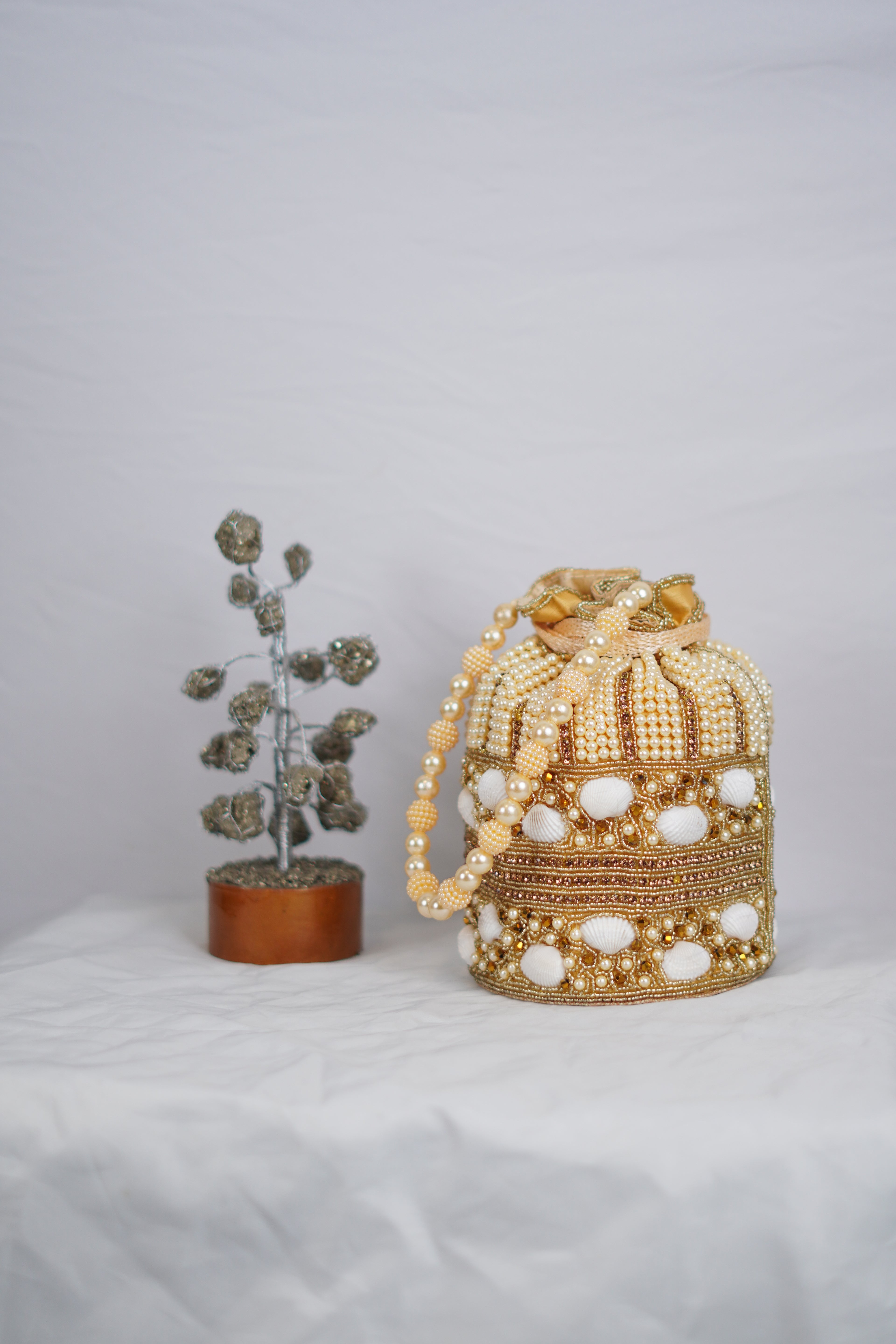 Shell work golden Potli