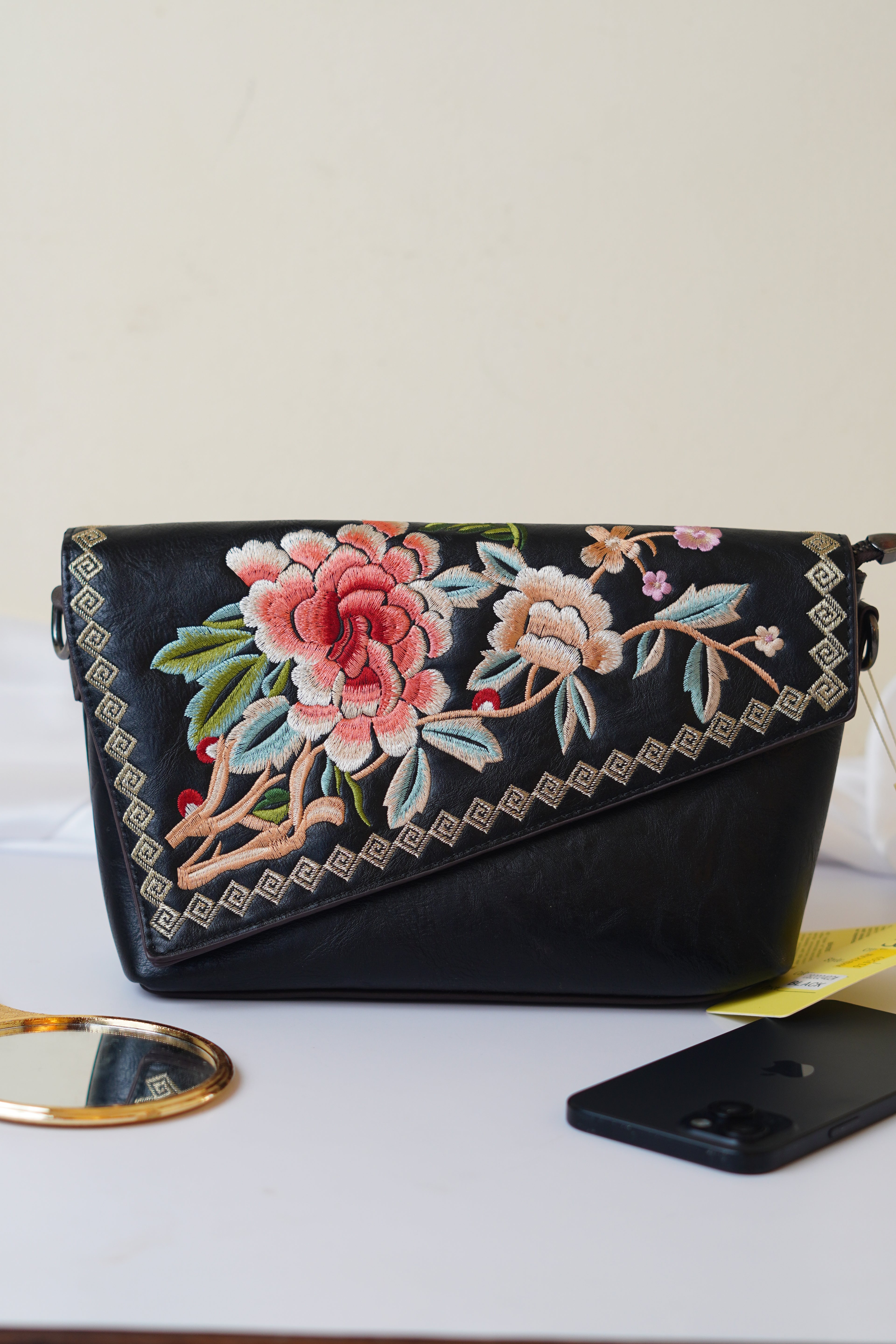 Embroidered black sling bag