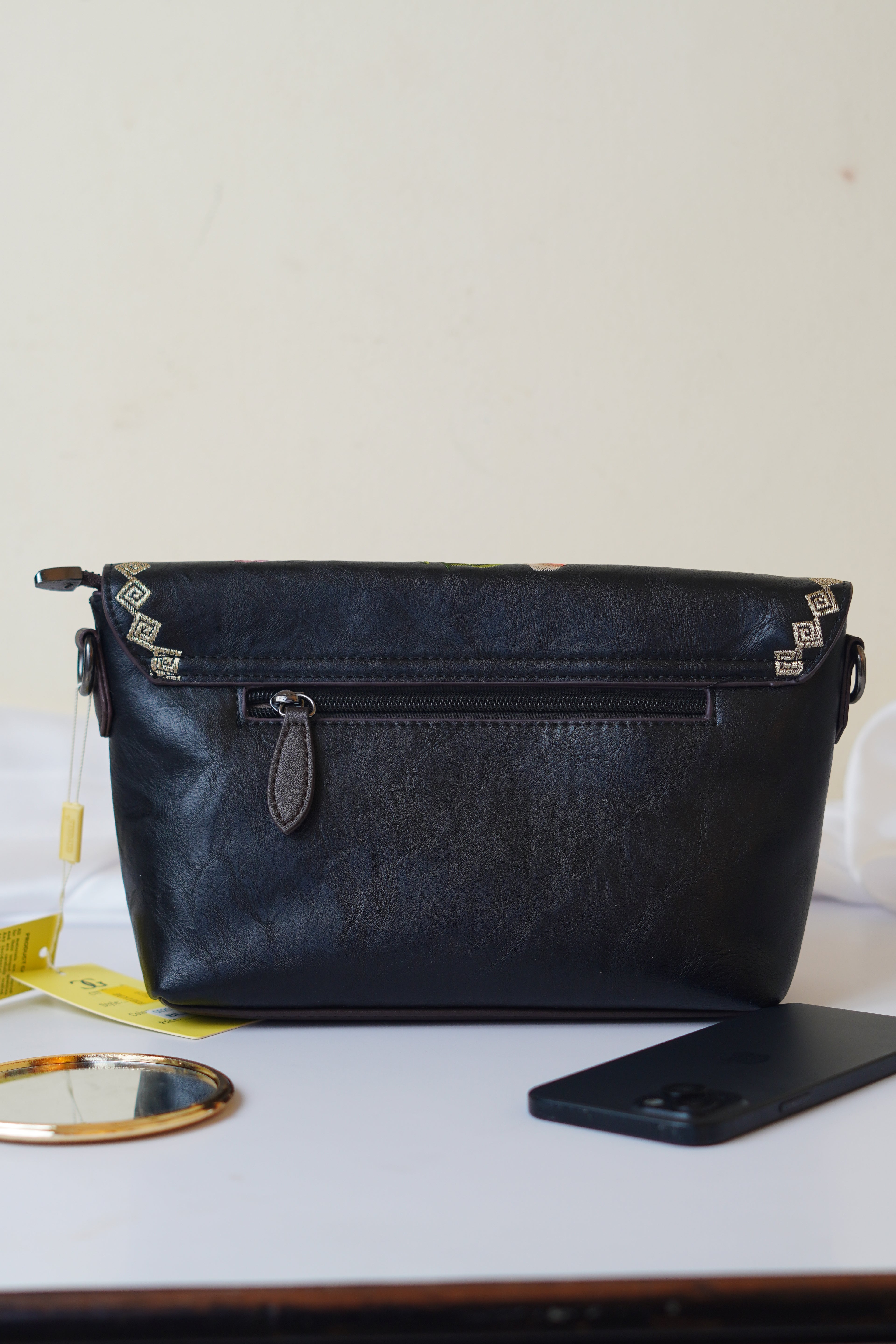 Embroidered black sling bag